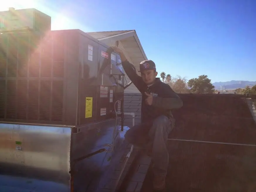 HVAC technician performing HVAC Inspection on a rooftop unit in Bainbridge